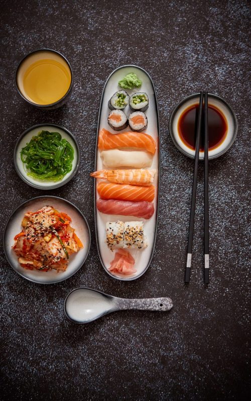 asian-food-assortment-various-sushi-rolls-placed-ceramic-plates-kimchi-goma-wakame-salads-soy-souce-chopsticks-sides-grungy-dark-background-with-copy-space (2)