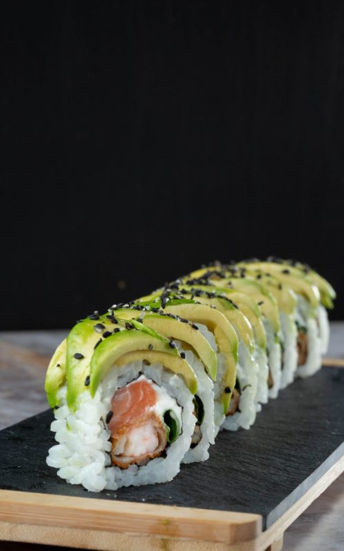 closeup-japanese-traditional-rolls-sushi-black-stone-plate